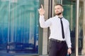 A young businessman pushes his index finger against a virtual screen