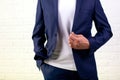 Young businessman putting on his jacket isolated over white. Croped shot