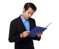 Young businessman read on clipboard