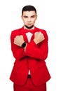 Young businessman is ready to defend their interests at any cost. bearded man in a red suit crosses his arms