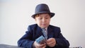 Young businessman recounting dollar banknote and looking through magnifying glass. Scrupulous businessman checking money