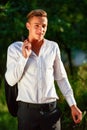 Young businessman relaxes in park