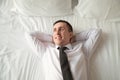 Young businessman relaxing in bed Royalty Free Stock Photo