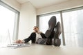 Young businessman relaxing at work desk in modern office.