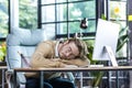 Young businessman resting in office, man in glasses sleeping on table Royalty Free Stock Photo