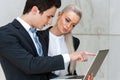 Businessman reviewing work with female colleague.