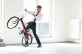 Young Businessman Rides on His Bike at Office. Business People Royalty Free Stock Photo