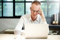 Young businessman seriously working on computer laptop in office