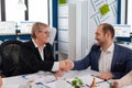 Young businessman shaking hands with client after agreement