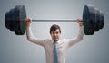 Young businessman in shirt is lifting heavy weights Royalty Free Stock Photo