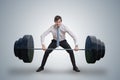 Young businessman in shirt is lifting heavy weights. Royalty Free Stock Photo