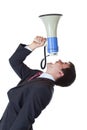 Young businessman shouts loudly in megaphone Royalty Free Stock Photo
