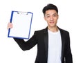 Young businessman show with clipboard and white paper