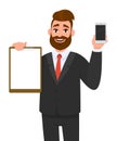 Young businessman showing blank clipboard and new brand mobile or smartphone in hand. Person holding notepad. Male character. Royalty Free Stock Photo