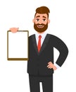 Young businessman showing blank clipboard. Person holding notepad. Male character design illustration. Human emotions.