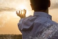 Businessman shows the network integrating in nature on the background of a sunny sunset