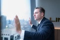 Young businessman sit and relax in the relaxation room by the window overlooking the beautiful city buildings Royalty Free Stock Photo