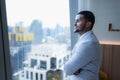 Young businessman sit and relax in the relaxation room by the window overlooking the beautiful city buildings. Royalty Free Stock Photo