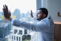 Young businessman sit and relax in the relaxation room by the window overlooking the beautiful city buildings. Royalty Free Stock Photo