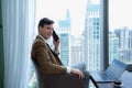 Young businessman sit and relax in the relaxation room by the window overlooking the beautiful city buildings. Royalty Free Stock Photo
