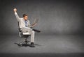 Young businessman sitting in chair with laptop Royalty Free Stock Photo