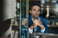 Young businessman looking through the window of a cafe Royalty Free Stock Photo