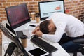 young businessman sitting near computers, smartphone Royalty Free Stock Photo