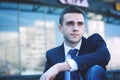 Young businessman sitting on the steps of the office Royalty Free Stock Photo