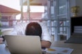 Young businessman sleeping and overworked near laptop at office. Royalty Free Stock Photo