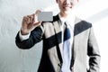 Young businessman smile and holding blank business card in office, business concept Royalty Free Stock Photo