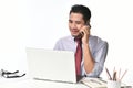 Businessman smiling while talking on the phone and working with laptop computer Royalty Free Stock Photo