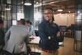 Young businessman smiling while working in a modern office Royalty Free Stock Photo