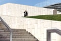 Young businessman speaking on mobile phone smartphone while standing on concrete stairs outside Royalty Free Stock Photo