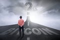 Young businessman standing above bitcoin word Royalty Free Stock Photo