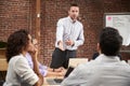 Young Businessman Standing And Leading Office Meeting Around Table Royalty Free Stock Photo