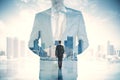 Young businessman standing on bright city background with mock up place. Future, success and career concept. Double exposure Royalty Free Stock Photo