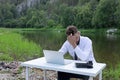 Young businessman in state of stress, fatigue and headache, he holds hand to his head. Young man having trouble studying