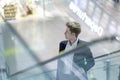 Double exposure of a young man in a suit on an escalator at the airport