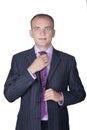 Young businessman in suit straightens his tie Royalty Free Stock Photo