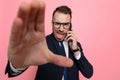 Young businessman talking on the phone and framing Royalty Free Stock Photo