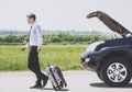 Young Businessman with Suitcase Walks Away on Road Royalty Free Stock Photo