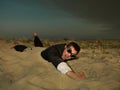 Young businessman swimming through sand in suit Royalty Free Stock Photo