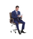 Young businessman with tablet sitting in comfortable office chair Royalty Free Stock Photo