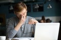 Young businessman taking off glasses feeling eyestrain tired of