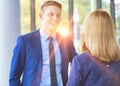 Young businessman talking with businesswoman in office during meeting Royalty Free Stock Photo