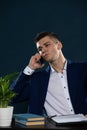 A young businessman is talking on his cell phone in his office. Royalty Free Stock Photo