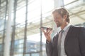 Young businessman talking on mobile phone in lobby office Royalty Free Stock Photo