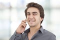Young businessman talking mobile phone in the office Royalty Free Stock Photo