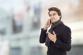 Young businessman talking mobile phone on street Royalty Free Stock Photo