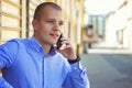 Young businessman talking on mobile phone on street Royalty Free Stock Photo